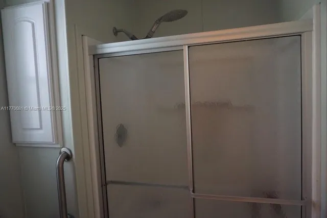 a kitchen with refrigerator and cabinets