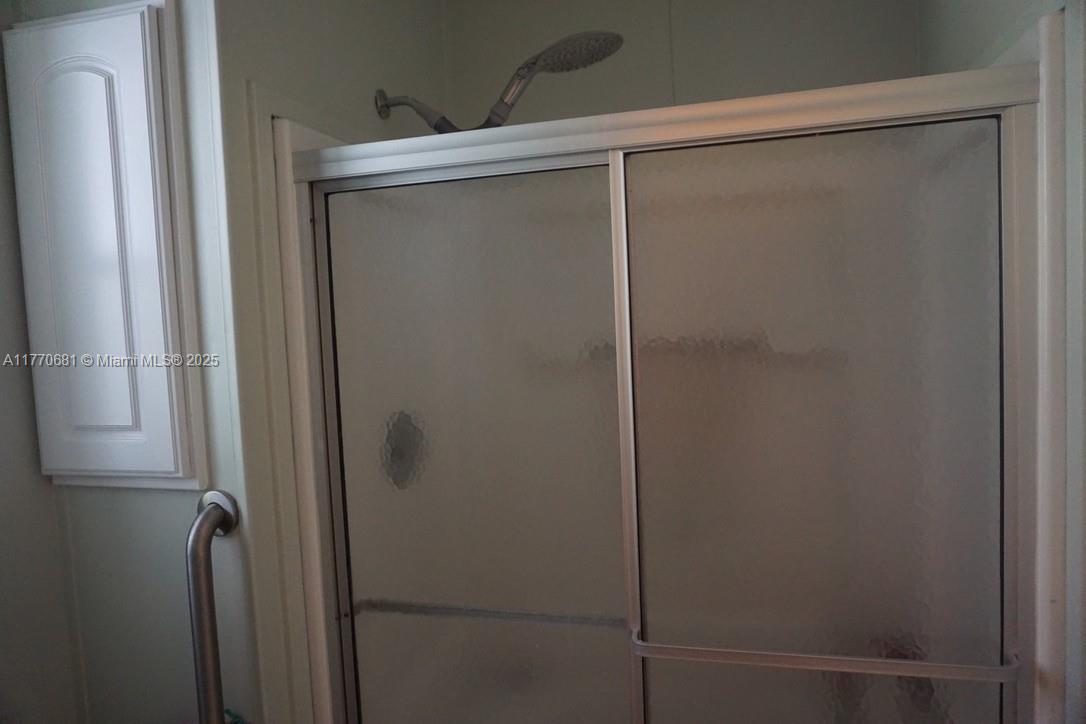 11 Old State Road Key Largo, FL 33037 - Photo 42 of 100 a bathroom with a glass shower door