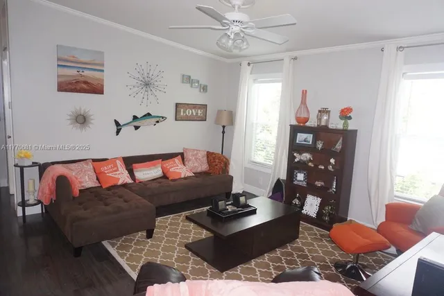 a dining room with furniture a rug a mirror and a chandelier