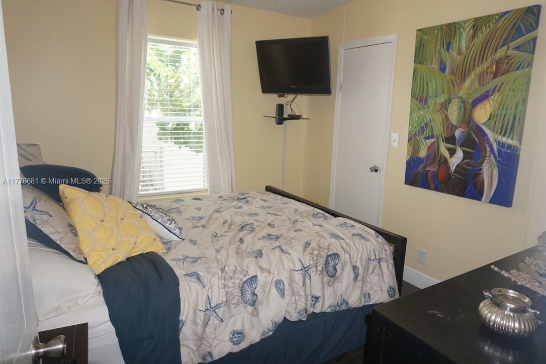 11 Old State Road Key Largo, FL 33037 - Photo 53 of 100 a bedroom with a bed and a flat screen tv