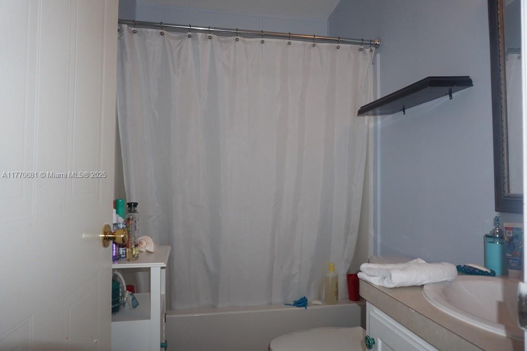 11 Old State Road Key Largo, FL 33037 - Photo 58 of 100 a bath room with a shower curtain and a sink