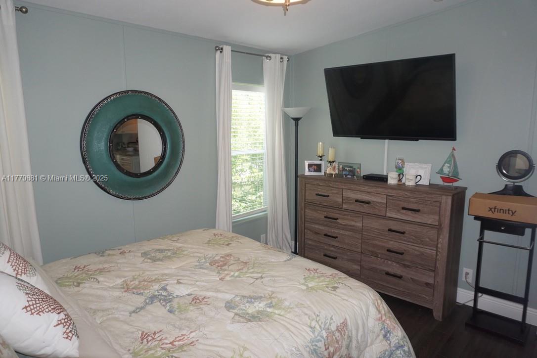 11 Old State Road Key Largo, FL 33037 - Photo 71 of 100 a bedroom with a bed and a flat screen tv in it