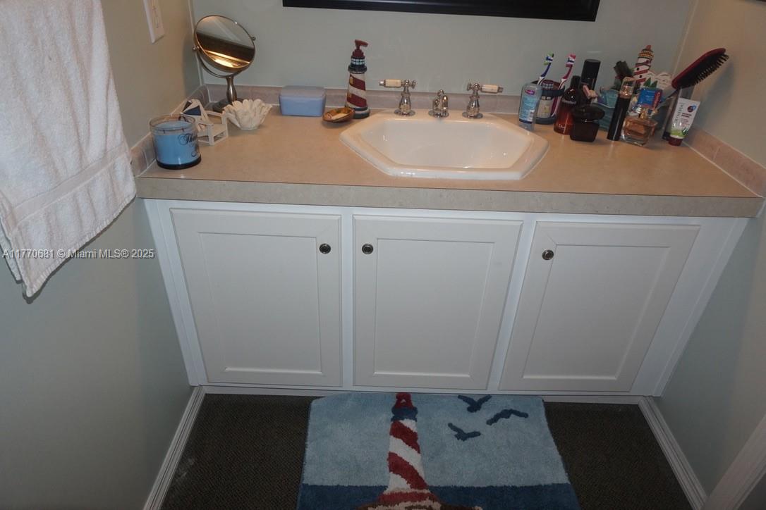 11 Old State Road Key Largo, FL 33037 - Photo 72 of 100 a bathroom with a sink and a mirror