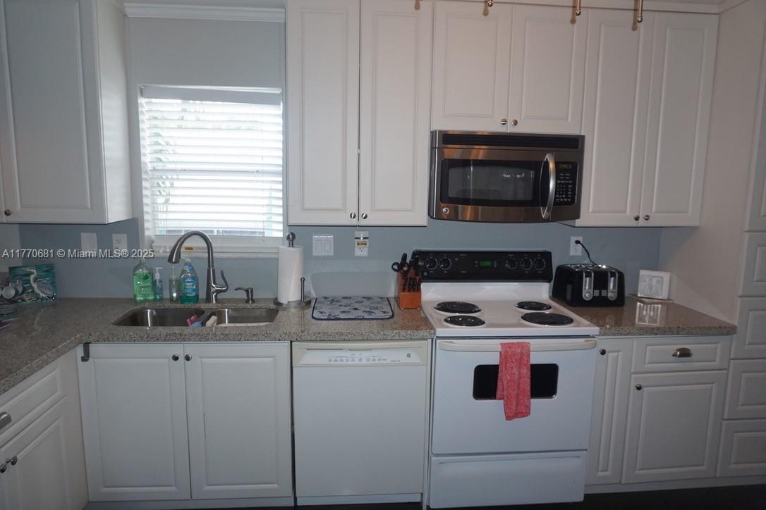 11 Old State Road Key Largo, FL 33037 - Photo 77 of 100 a kitchen with cabinets appliances a sink and a counter top