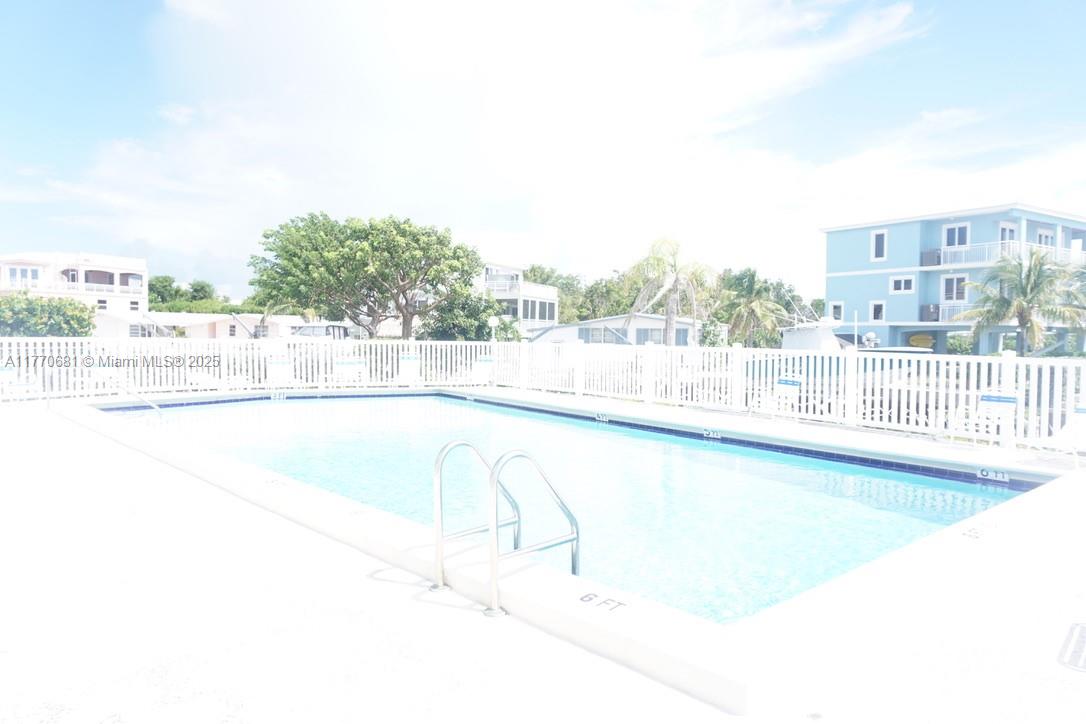 11 Old State Road Key Largo, FL 33037 - Photo 86 of 100 a view of a swimming pool with an outdoor seating