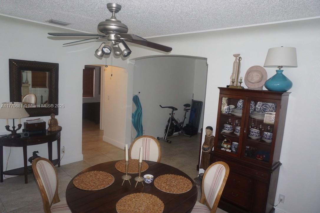 11 Old State Road Key Largo, FL 33037 - Photo 93 of 100 a dining room with furniture a rug a mirror and a chandelier
