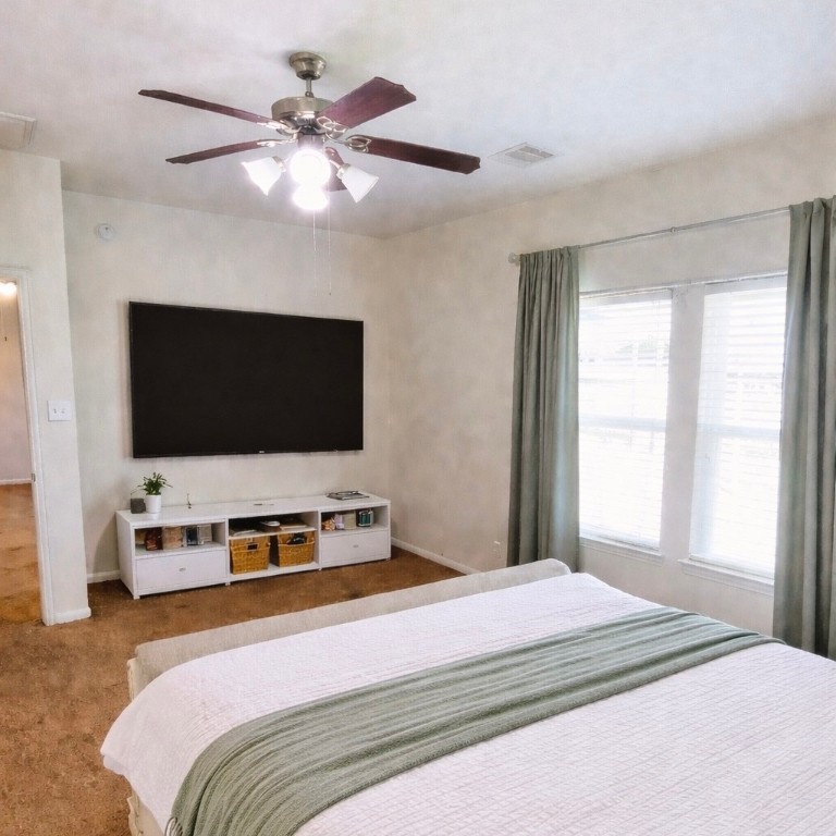 8626 Willet Street Baytown, TX 77521 - Photo 12 of 29 a bedroom with a bed and a flat screen tv