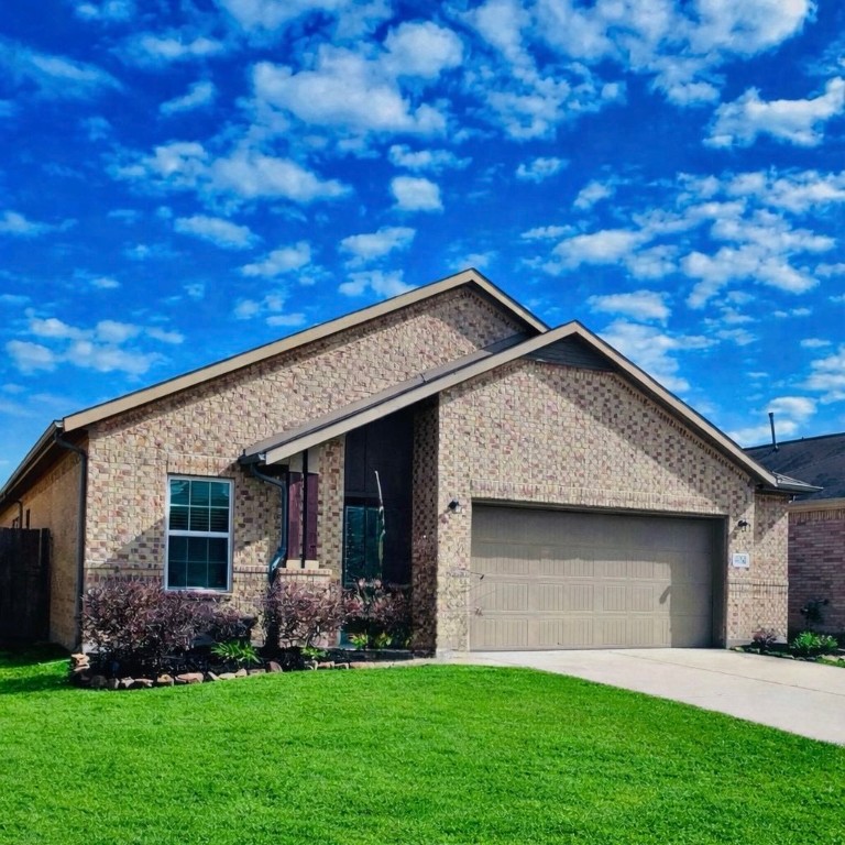 8626 Willet Street Baytown, TX 77521 - Photo 2 of 29 a front view of a house with a yard and garage