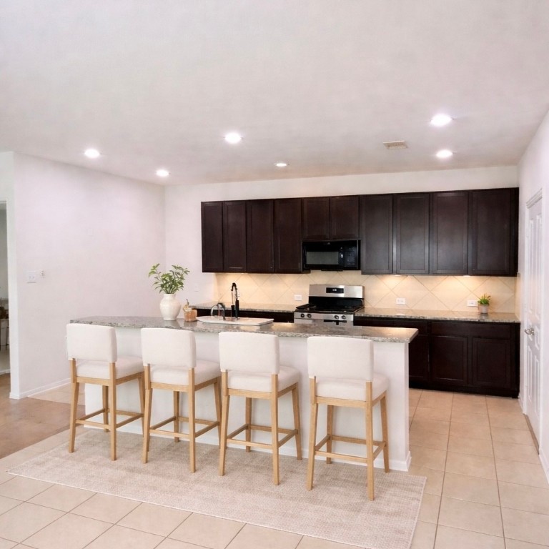 8626 Willet Street Baytown, TX 77521 - Photo 6 of 29 a kitchen with stainless steel appliances kitchen island granite countertop a sink and cabinets