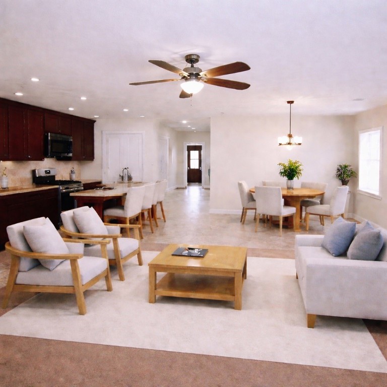 8626 Willet Street Baytown, TX 77521 - Photo 7 of 29 a living room with furniture kitchen view and a chandelier