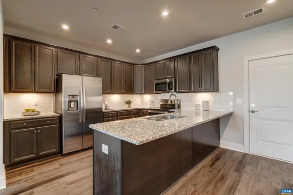 a kitchen with sink cabinets and stainless steel appliances