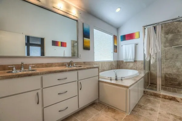 a bathroom with a granite countertop sink mirror and double