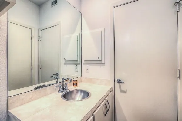 a bathroom with a sink and a mirror
