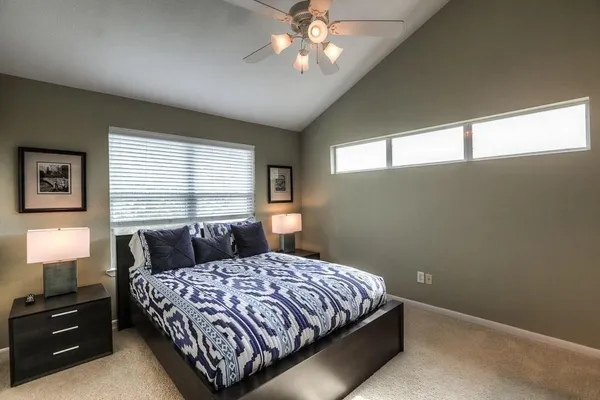 a bedroom with a bed and a chandelier