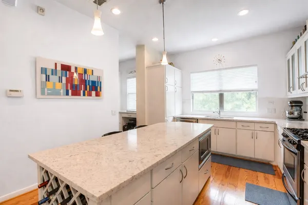 a kitchen with a stove a sink and a refrigerator