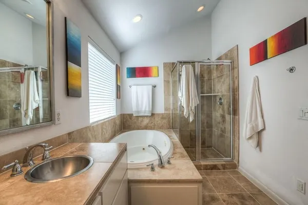 a bathroom with a sink a shower and a mirror