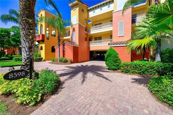 a view of a street with potted plants and palm trees