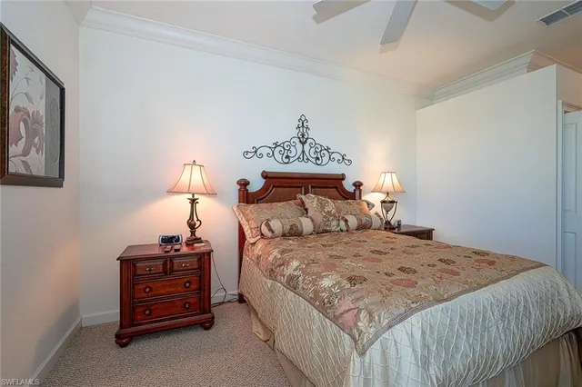 a bedroom with a bed and a lamp on table