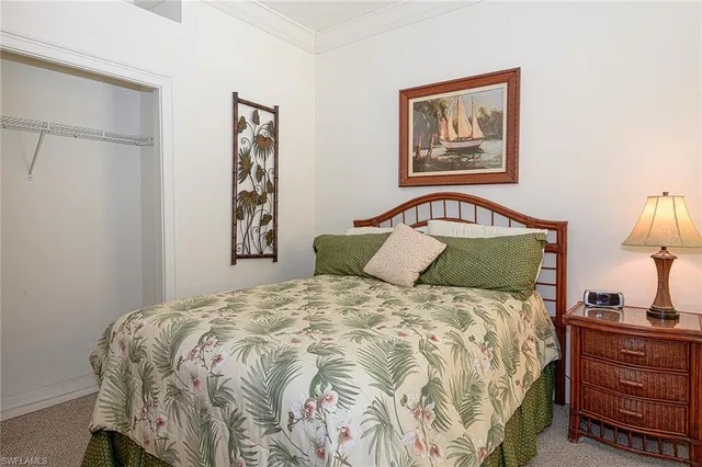 a bedroom with a bed and lamp