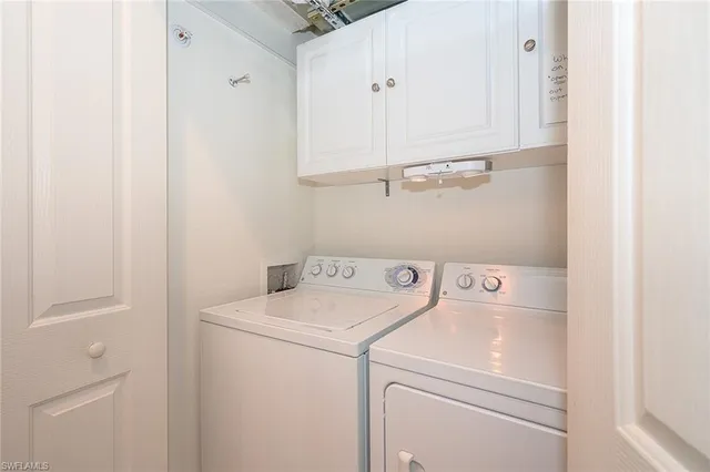 a view of storage and utility room with washer and dryer
