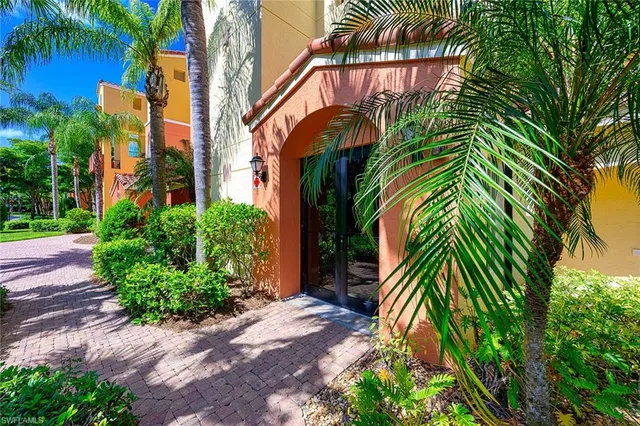 a view of a palm plant that is in front of a house