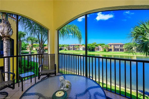 a view of a chairs and table in the balcony