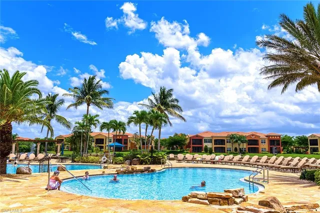 a view of swimming pool with outdoor seating and green space