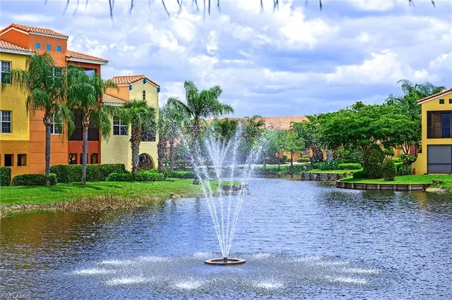 a building exterior with stairs and palm trees