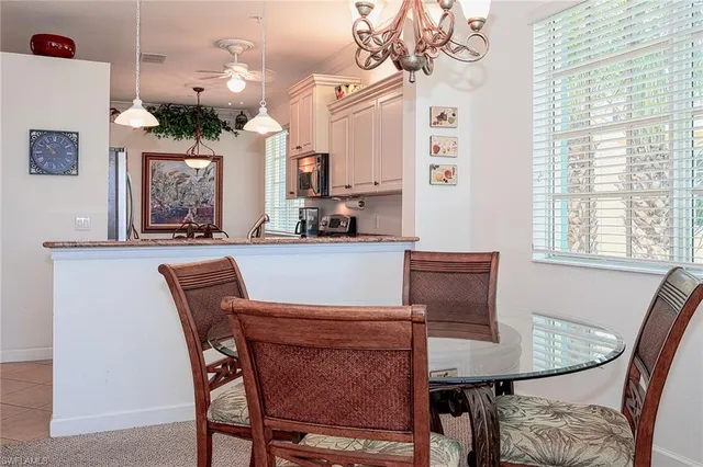 a view of a dining room with furniture and a chandelier
