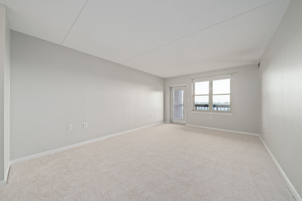 155 George Washington Boulevard, Unit 402 Hull, MA 02045 - Photo 13 of 42 a view of an empty room with a window