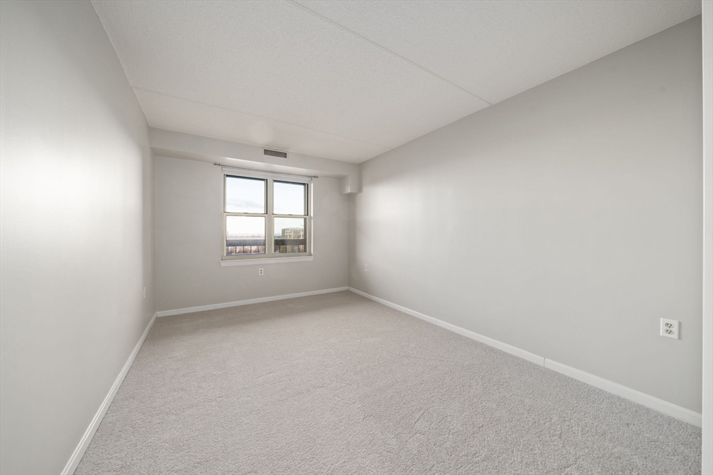 155 George Washington Boulevard, Unit 402 Hull, MA 02045 - Photo 17 of 42 an empty room with windows