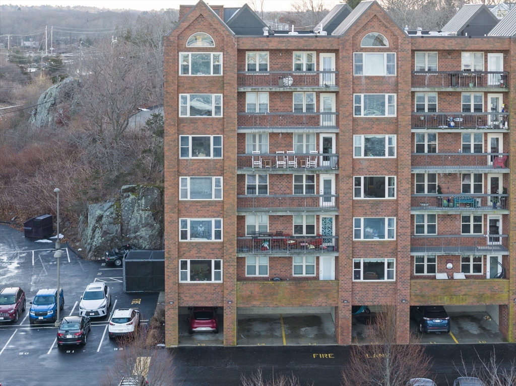 155 George Washington Boulevard, Unit 402 Hull, MA 02045 - Photo 30 of 42 a front view of a building with many windows