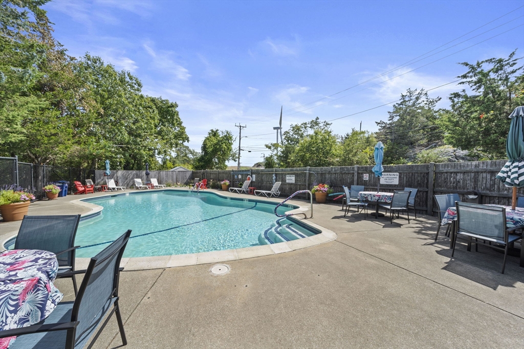 155 George Washington Boulevard, Unit 402 Hull, MA 02045 - Photo 33 of 42 a view of outdoor space yard swimming pool and furniture
