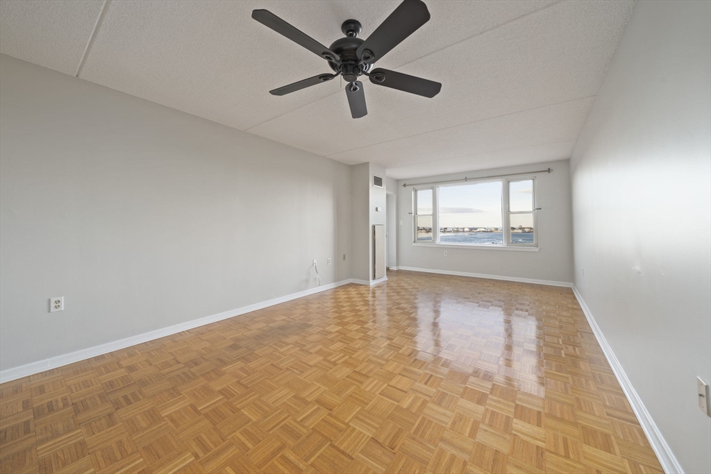 155 George Washington Boulevard, Unit 402 Hull, MA 02045 - Photo 9 of 42 wooden floor in an empty room with a window