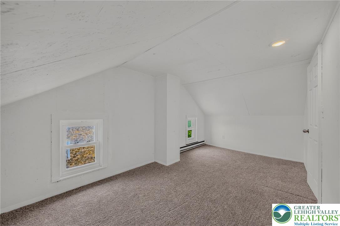313 Main Street Slatington, PA 18080 - Photo 59 of 73 A well-lit bedroom features ample natural light and plush carpeting, creating a comfortable and inviting atmosphere.