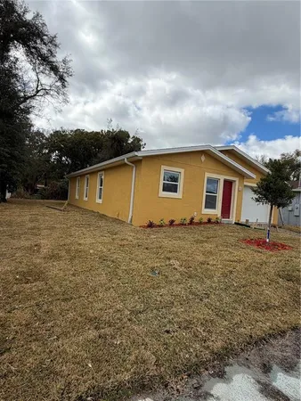 a backyard of a house with table and chairs