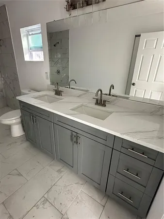 a bathroom with a double vanity sink and a mirror