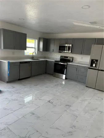 a kitchen with a refrigerator and a sink