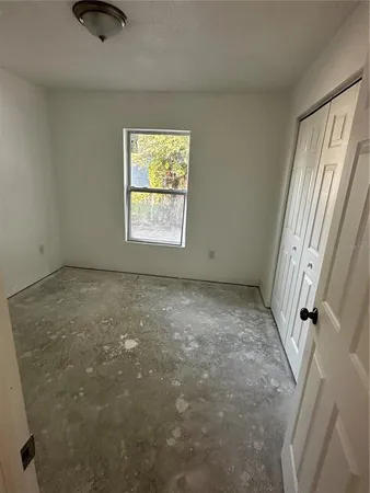 a view of an empty room and a window