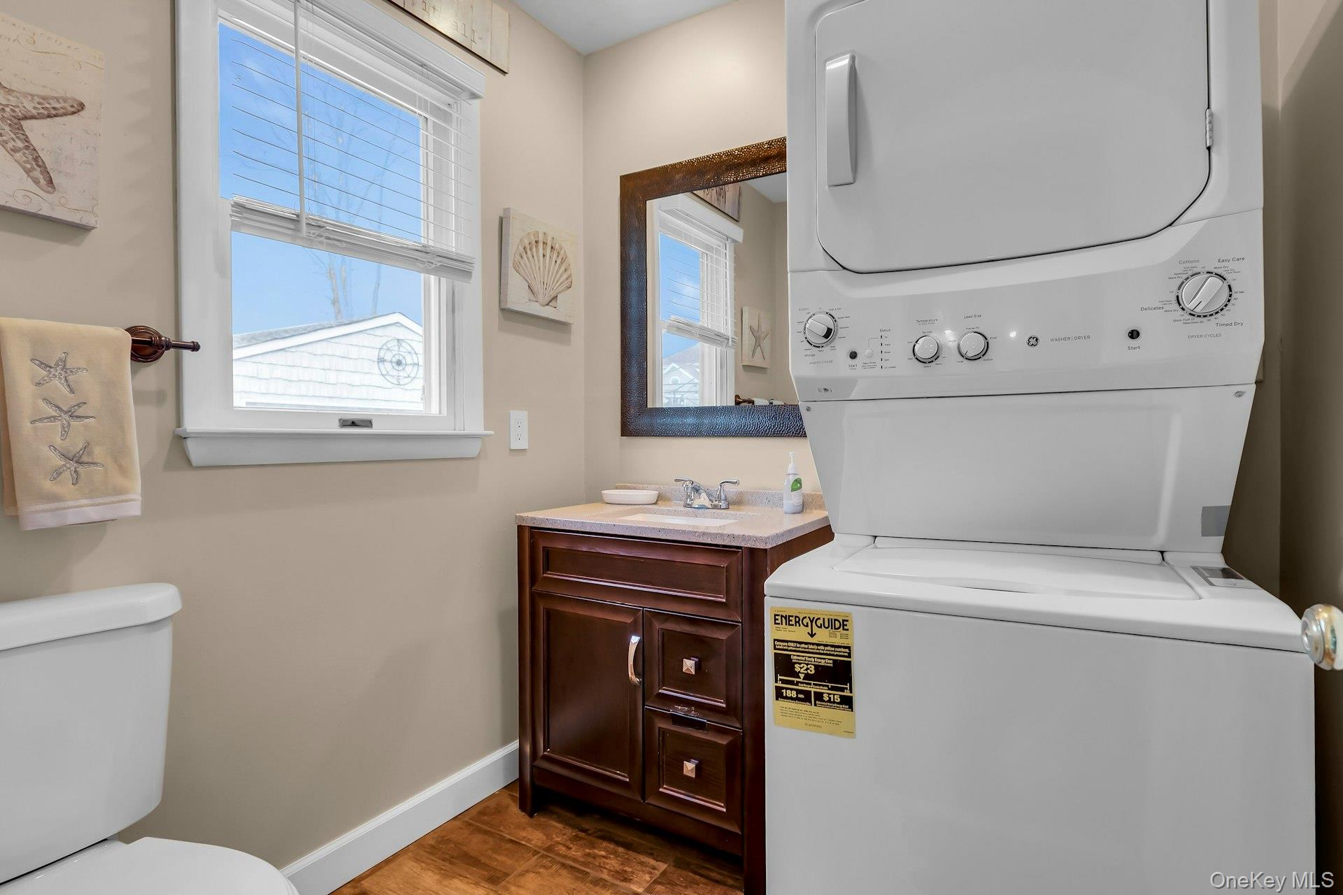 358 Rider Avenue Patchogue, NY 11772 - Photo 15 of 25 Washroom with baseboards and stacked washing machine and dryer