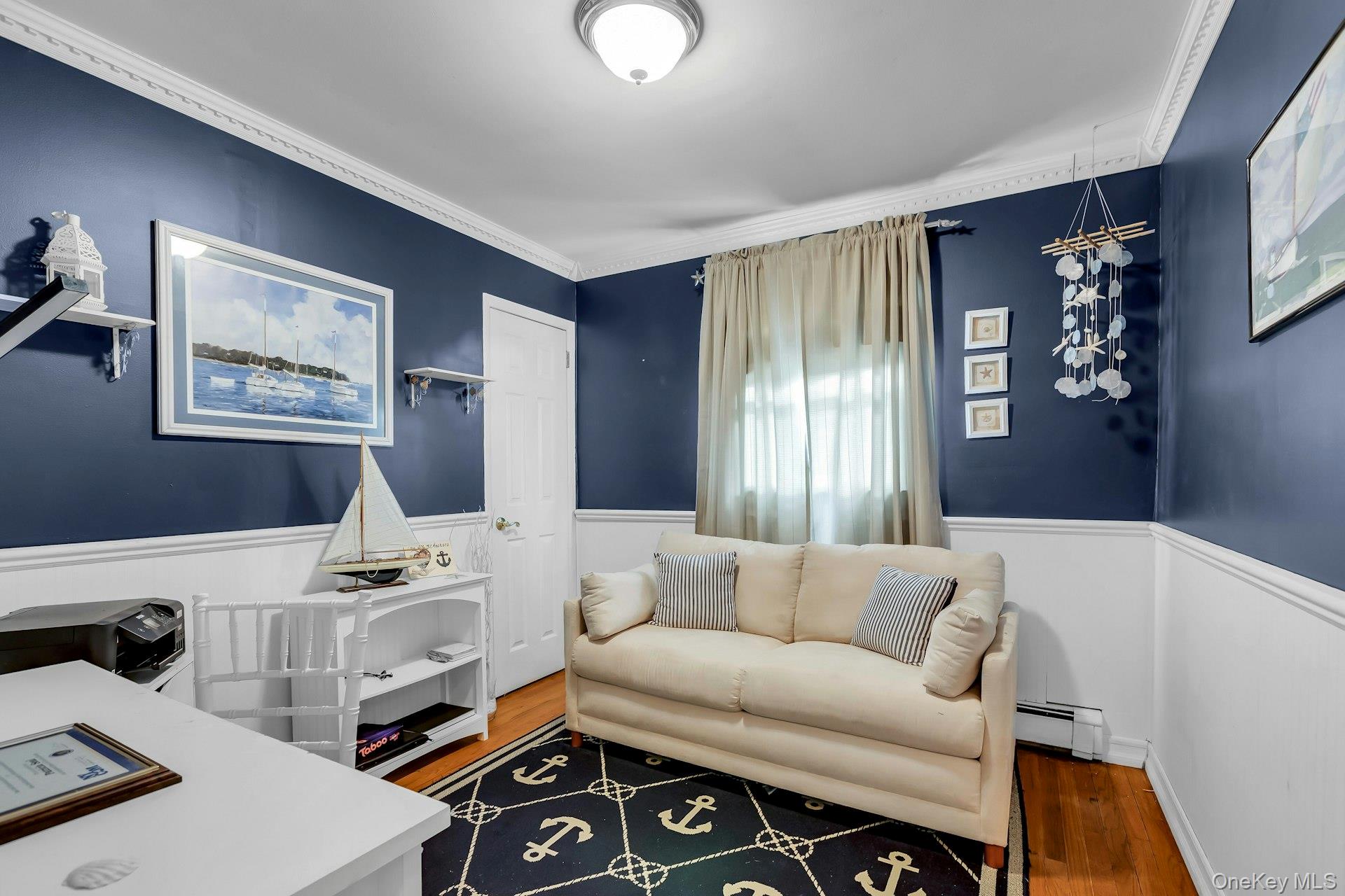 358 Rider Avenue Patchogue, NY 11772 - Photo 19 of 25 Home office with a wainscoted wall, ornamental molding, wood finished floors, and a baseboard heating unit