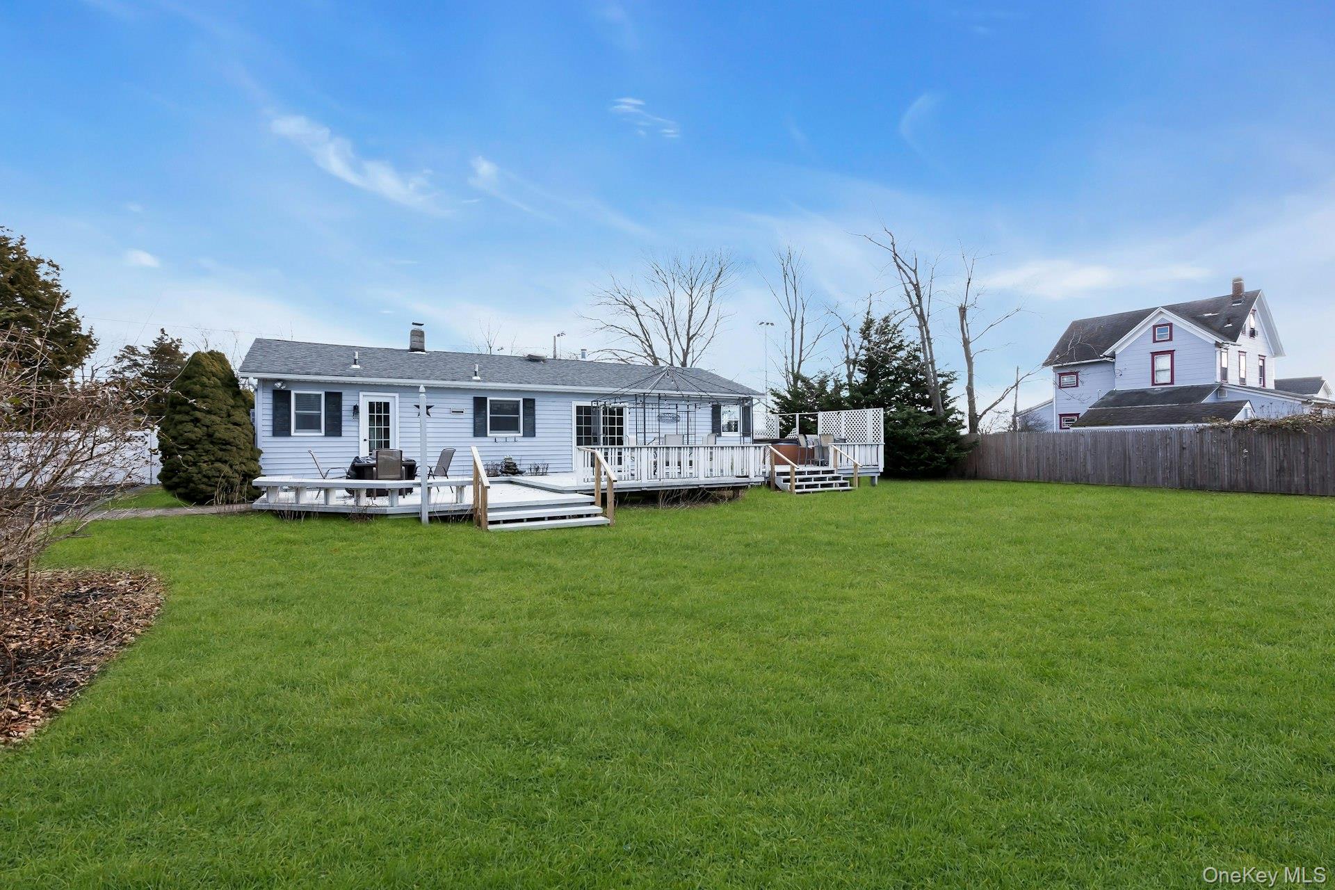 358 Rider Avenue Patchogue, NY 11772 - Photo 23 of 25 Rear view of house with a deck and a chimney