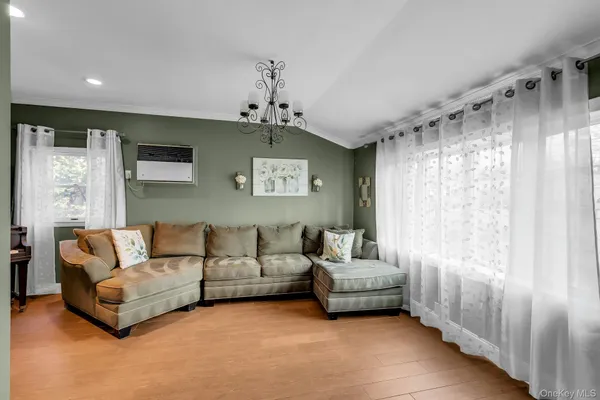 a living room with furniture and a chandelier