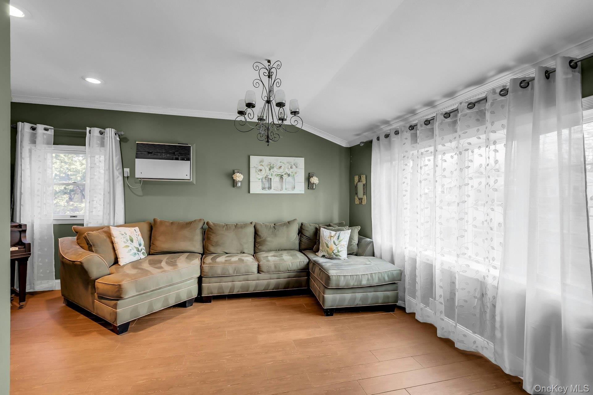 358 Rider Avenue Patchogue, NY 11772 - Photo 7 of 25 Living area featuring a chandelier, ornamental molding, and wood finished floors