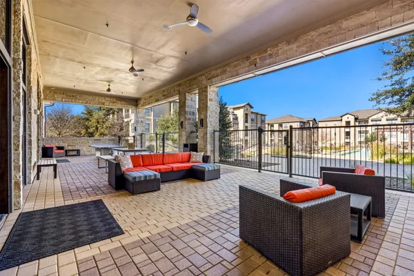 a living room with furniture and a floor to ceiling window