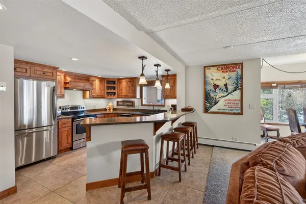 a kitchen with stainless steel appliances granite countertop a sink a stove and center island