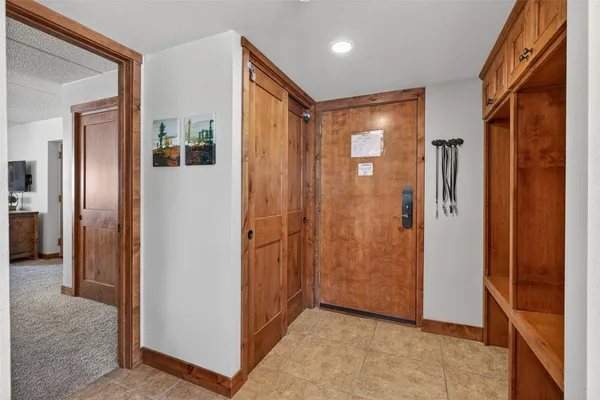 a bedroom with a bed a couch and a flat tv screen on dresser