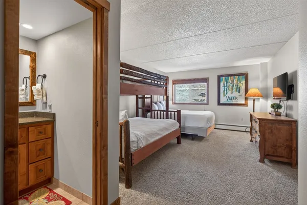 a bedroom with a bed next to a large window