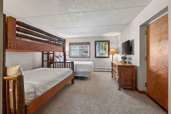 a bedroom with furniture and a flat screen tv