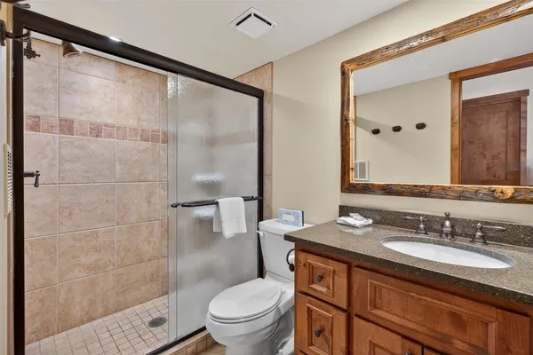 a bedroom with a bed a mirror and a window